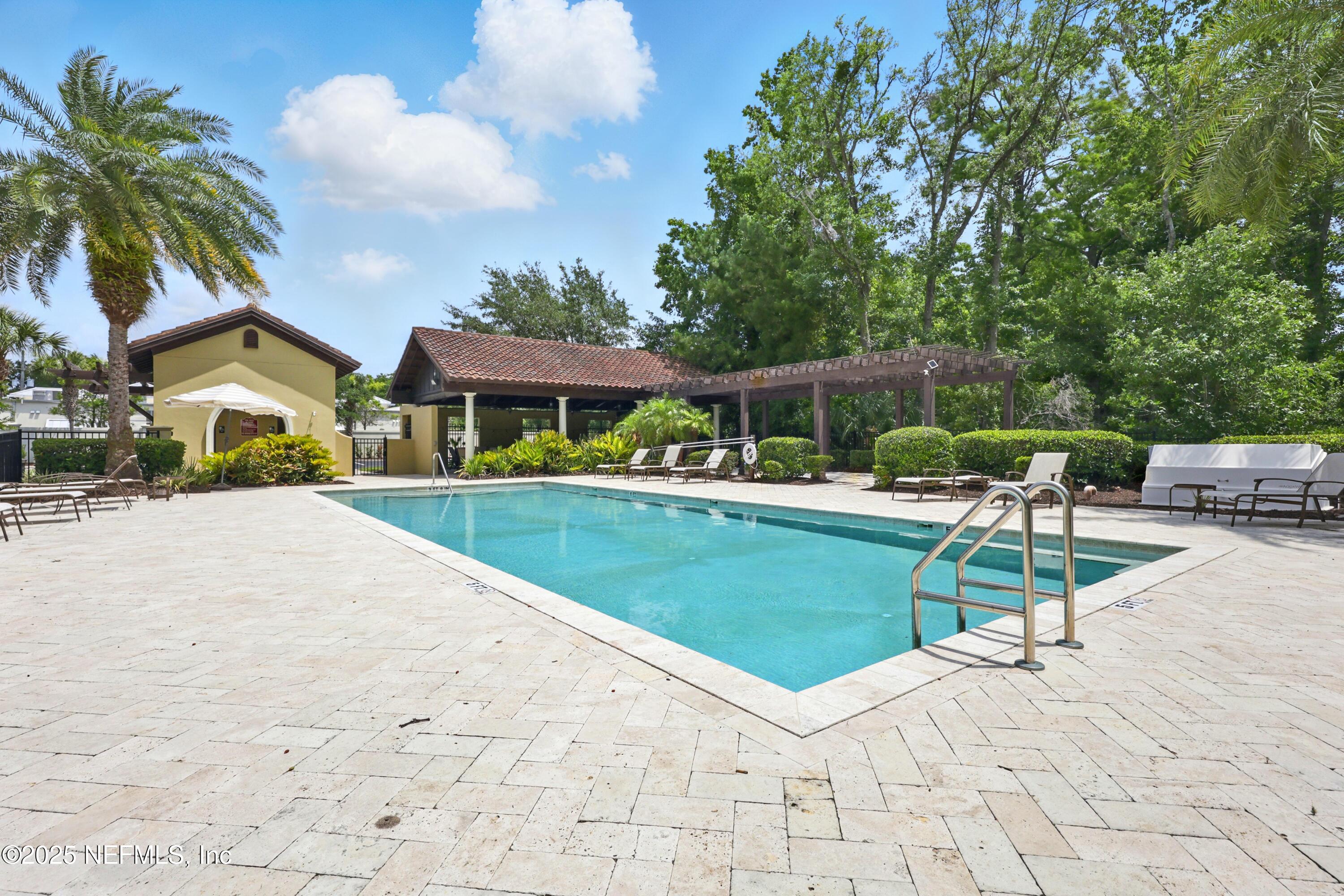 3958 Baymeadows Road, Unit 1602 Jacksonville, FL 32217 - Photo 79 of 89 a view of swimming pool with outdoor seating and house in the background