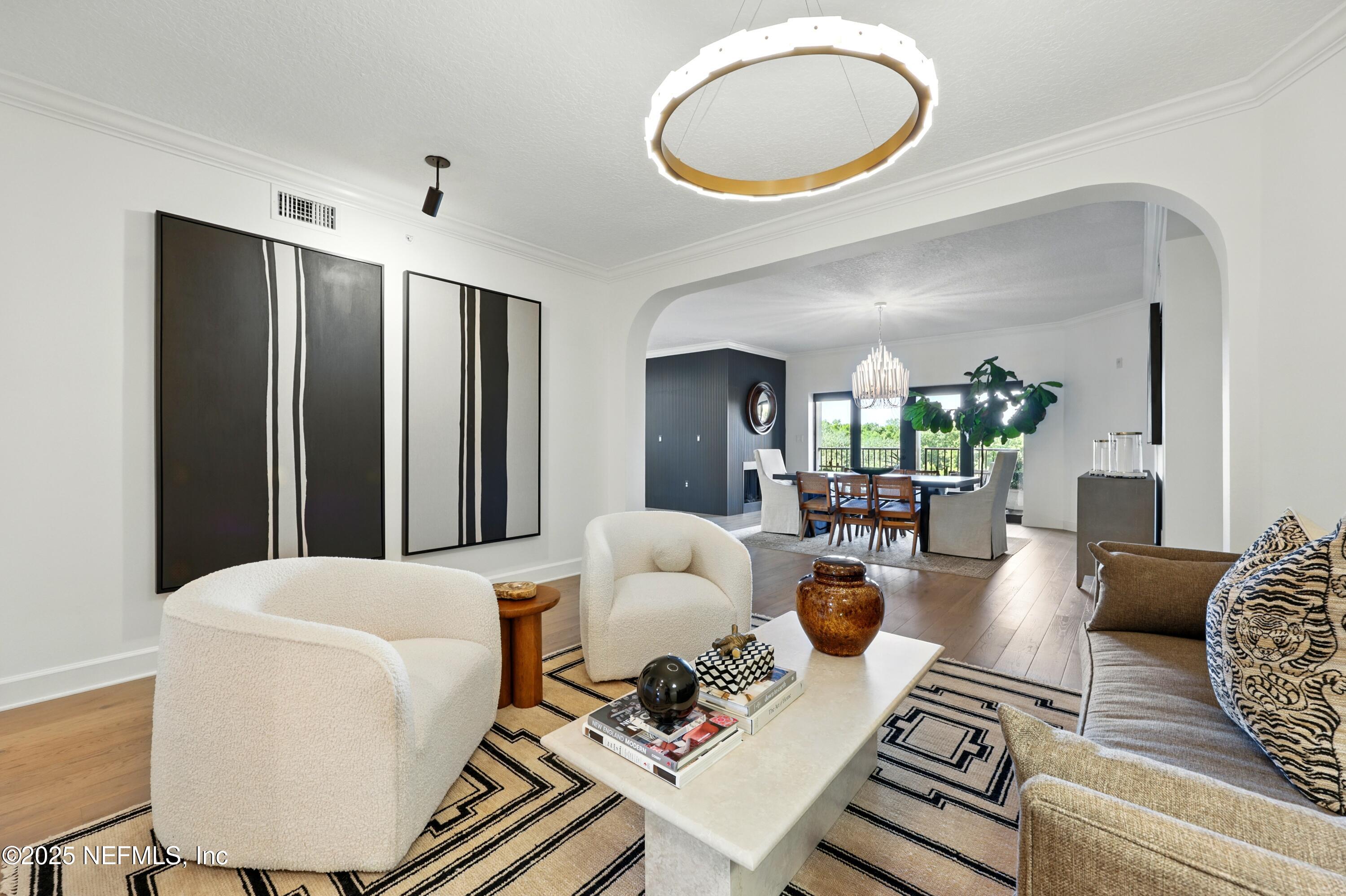 3958 Baymeadows Road, Unit 1602 Jacksonville, FL 32217 - Photo 8 of 89 a living room with furniture a fireplace and a large mirror