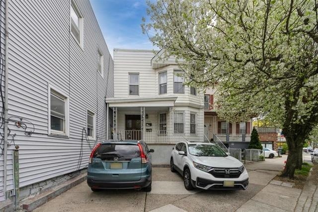 1012 Paterson Plank Road, Unit 1 North Bergen, NJ 07047 - Photo 1 of 13 a car parked in front of a white house
