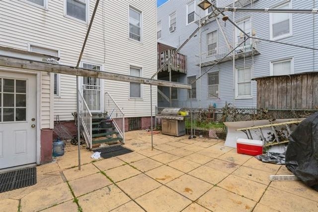 1012 Paterson Plank Road, Unit 1 North Bergen, NJ 07047 - Photo 12 of 13 a view of a patio with table and chairs and potted plants