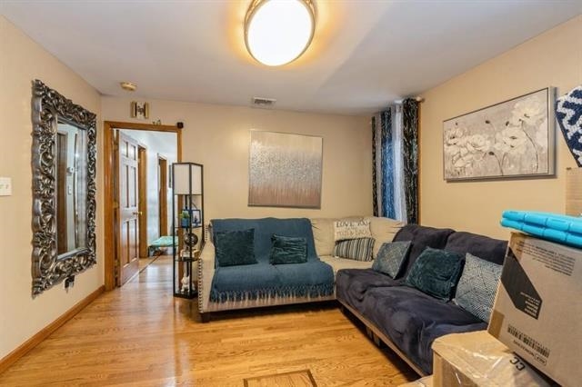 1012 Paterson Plank Road, Unit 1 North Bergen, NJ 07047 - Photo 3 of 13 a living room with furniture and a large window