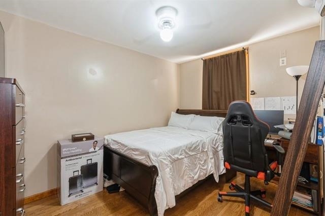 1012 Paterson Plank Road, Unit 1 North Bergen, NJ 07047 - Photo 7 of 13 a bedroom with a bed and a chandelier