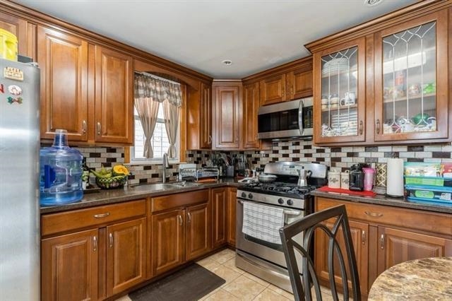 1012 Paterson Plank Road, Unit 1 North Bergen, NJ 07047 - Photo 9 of 13 a kitchen with stainless steel appliances a stove sink microwave and cabinets
