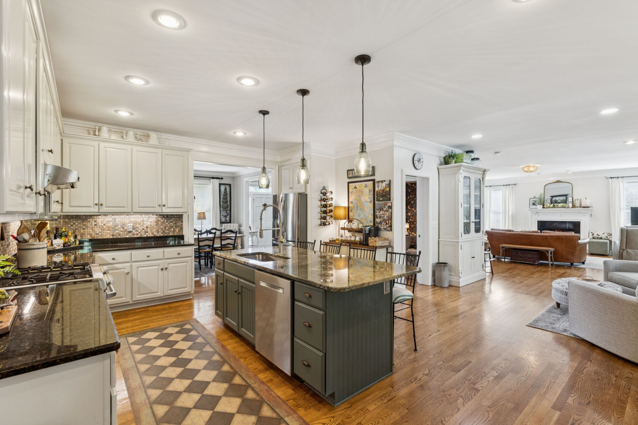 1909 Dr Robinson Rd Spring Hill Thompson's Station, TN 37179 - Photo 21 of 72 a kitchen with stainless steel appliances granite countertop a stove top oven a sink dishwasher a dining table and chairs with wooden floor