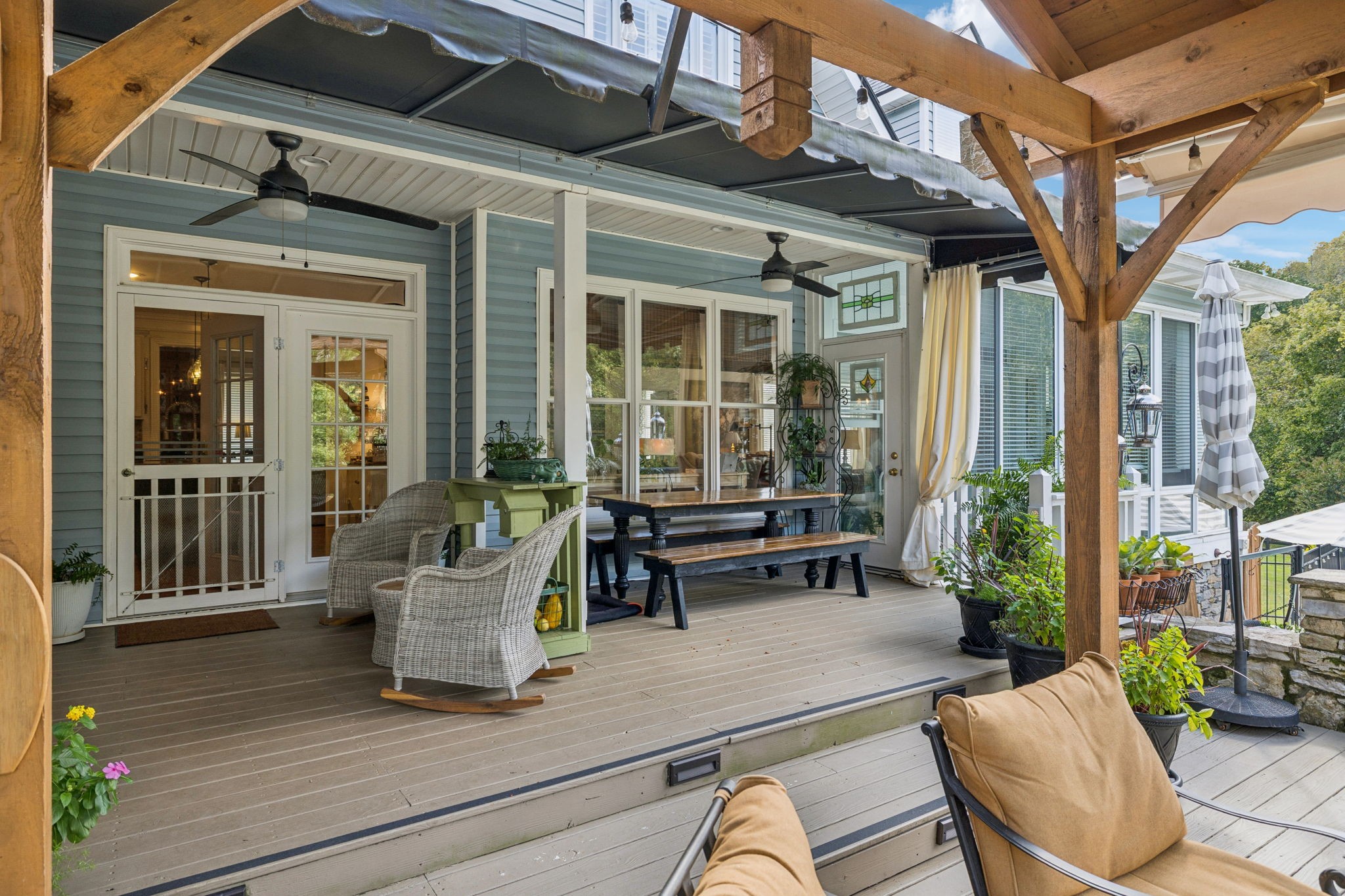 1909 Dr Robinson Rd Spring Hill Thompson's Station, TN 37179 - Photo 49 of 72 a view of a patio with couches table and chairs and potted plants