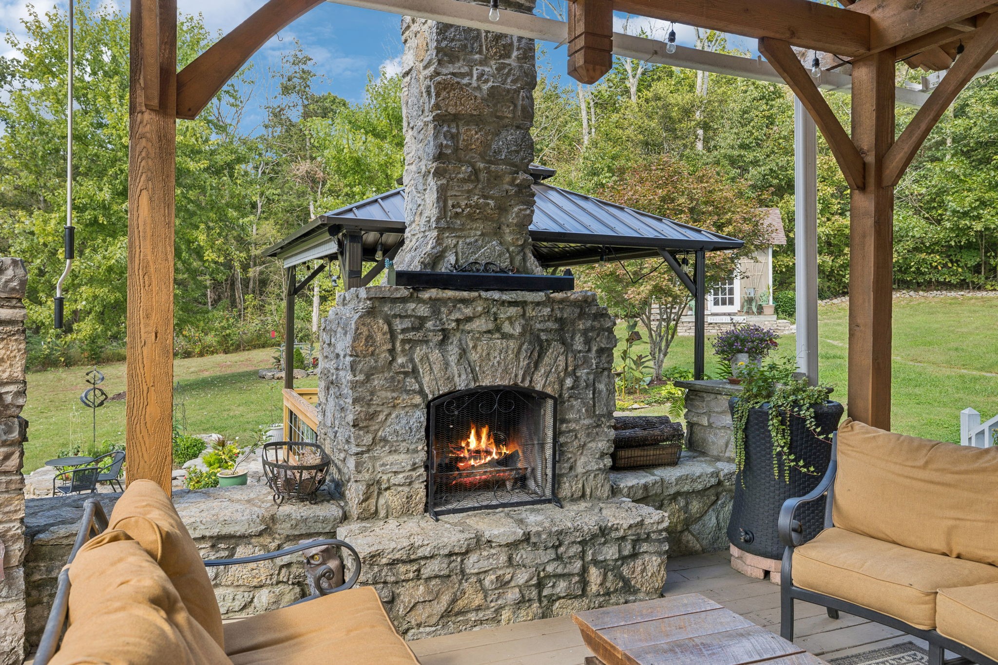 1909 Dr Robinson Rd Spring Hill Thompson's Station, TN 37179 - Photo 54 of 72 a view of a patio with a fireplace dining table and a chairs