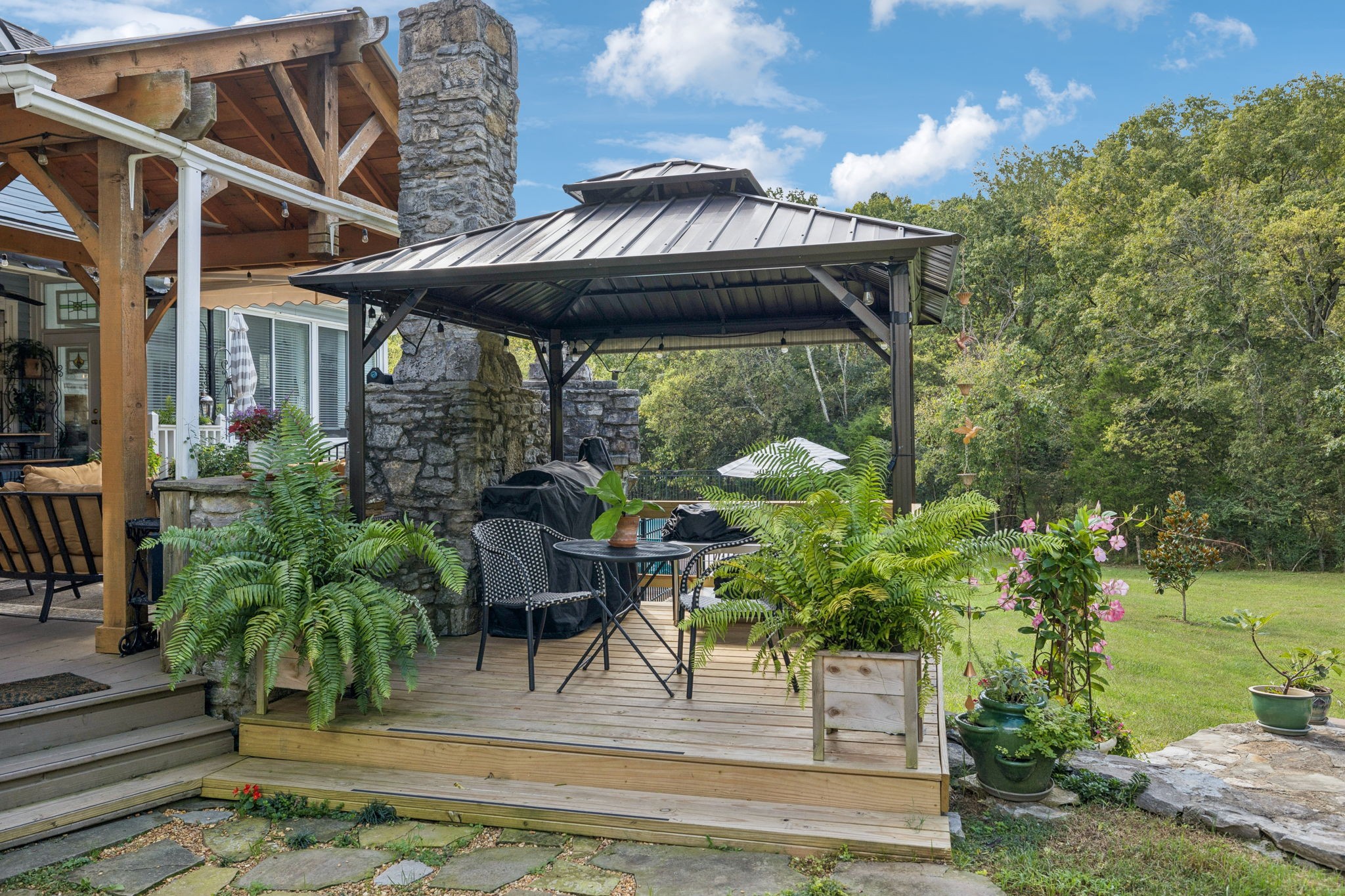 1909 Dr Robinson Rd Spring Hill Thompson's Station, TN 37179 - Photo 56 of 72 a view of a patio with table and chairs potted plants