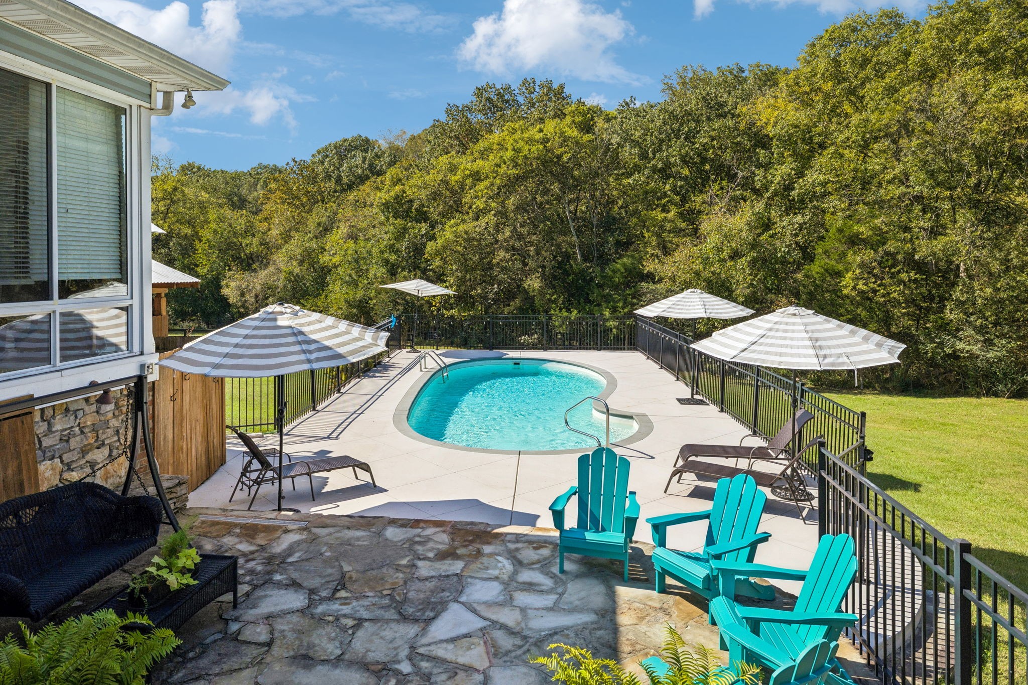 1909 Dr Robinson Rd Spring Hill Thompson's Station, TN 37179 - Photo 57 of 72 a view of a patio with chairs under an umbrella