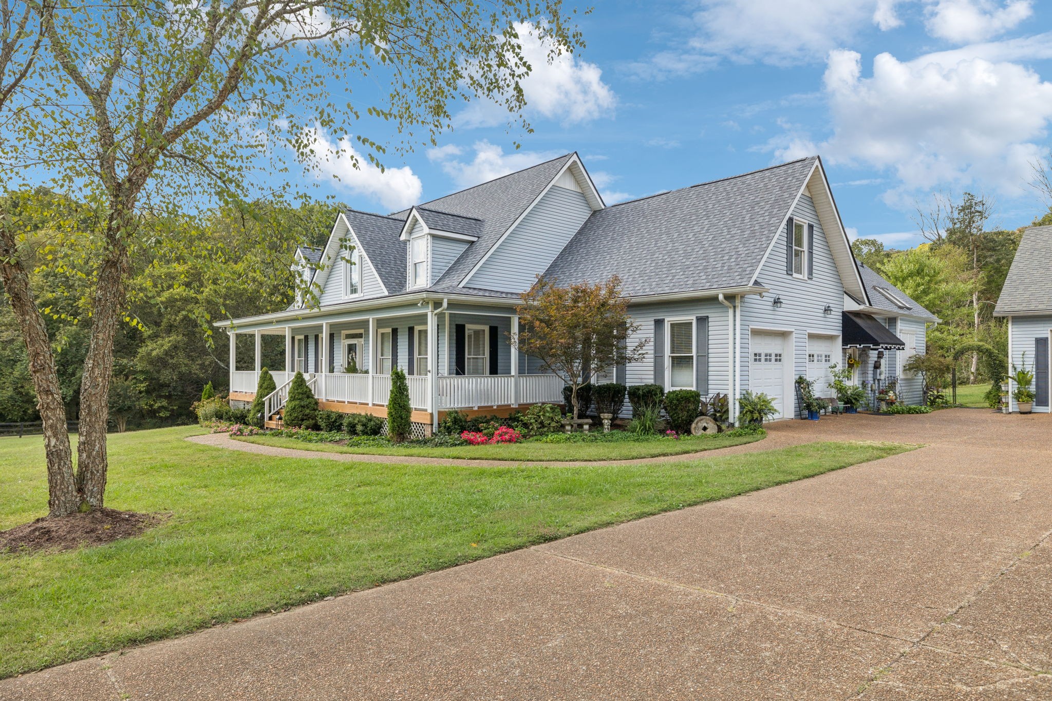 1909 Dr Robinson Rd Spring Hill Thompson's Station, TN 37179 - Photo 7 of 72 a front view of a house with a yard and garage