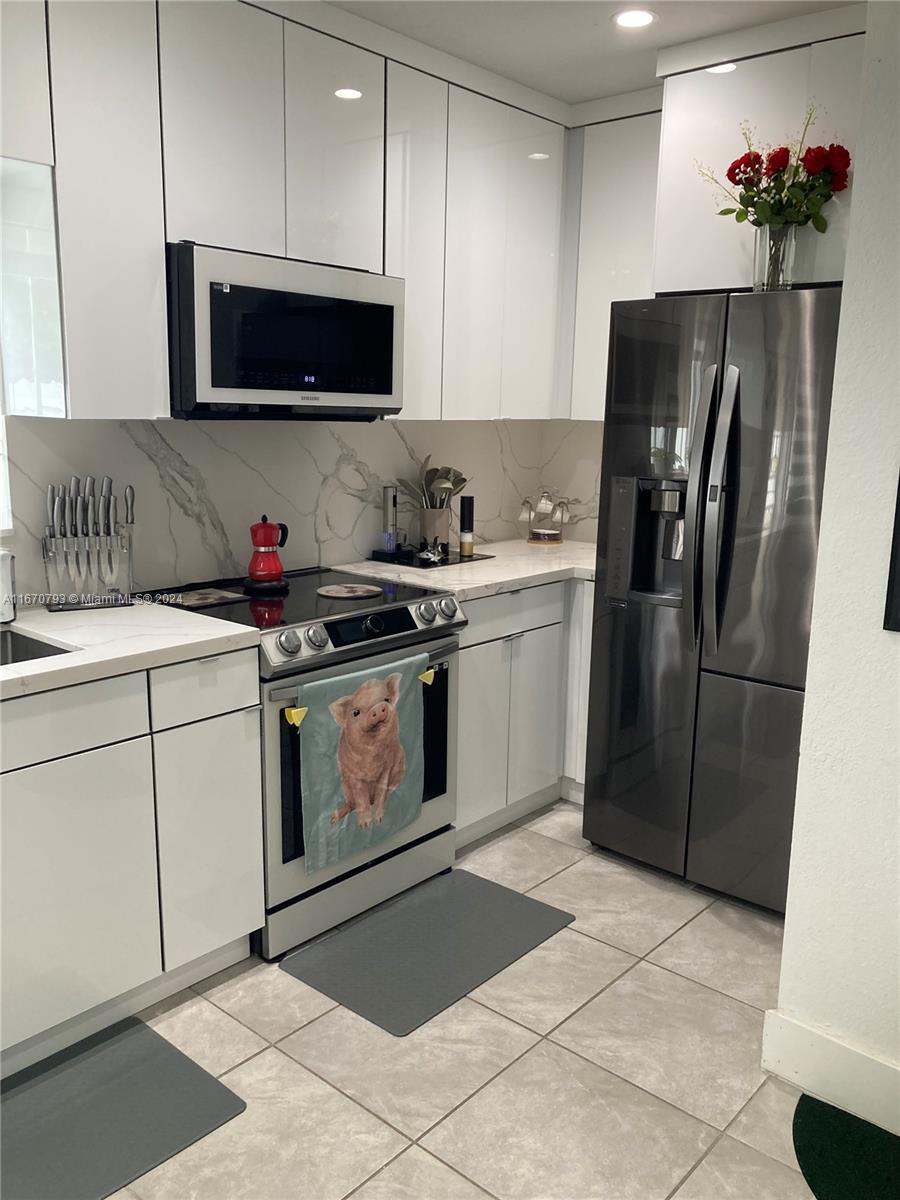 10831 West Old Cutler Road Miami, FL 33170 - Photo 5 of 14 a kitchen with a sink stove and refrigerator