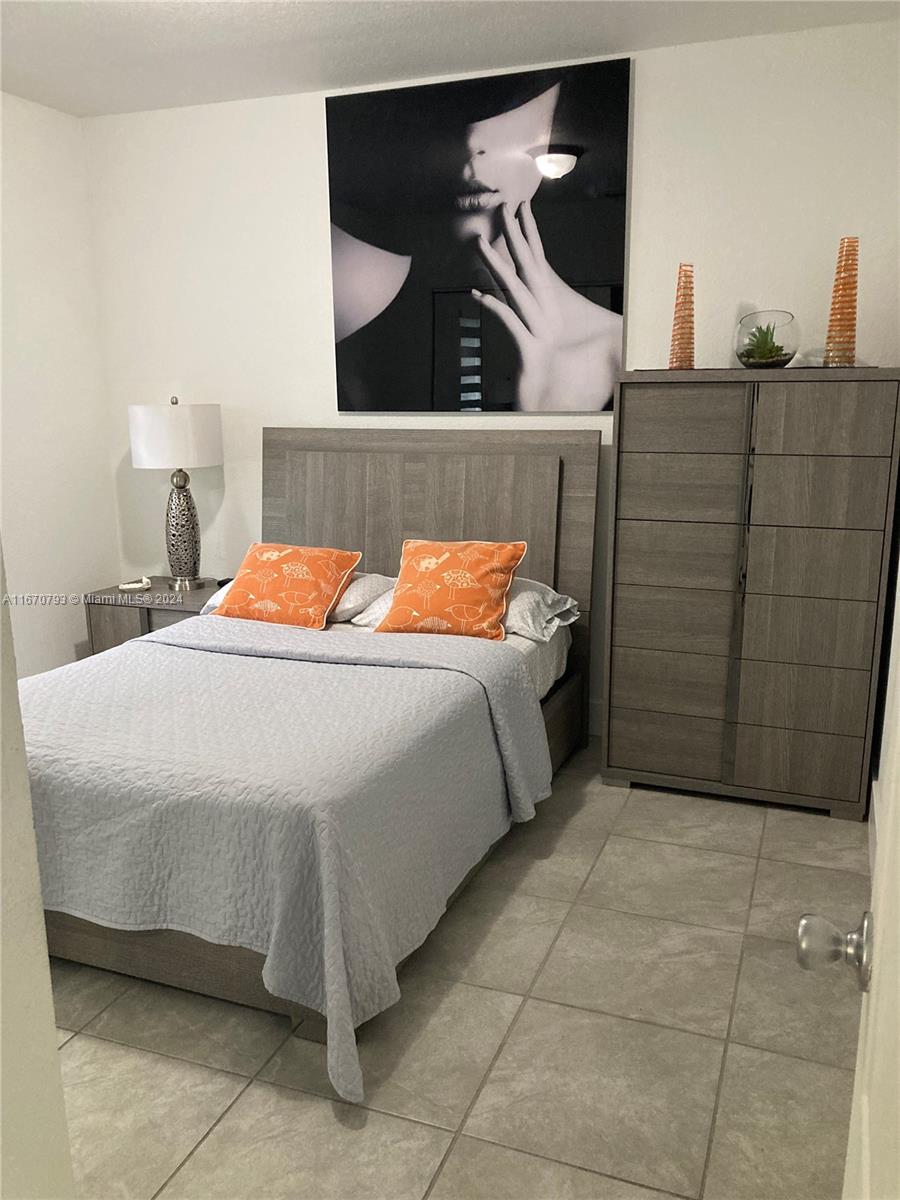 10831 West Old Cutler Road Miami, FL 33170 - Photo 7 of 14 a bedroom with a bed and a painting on the wall