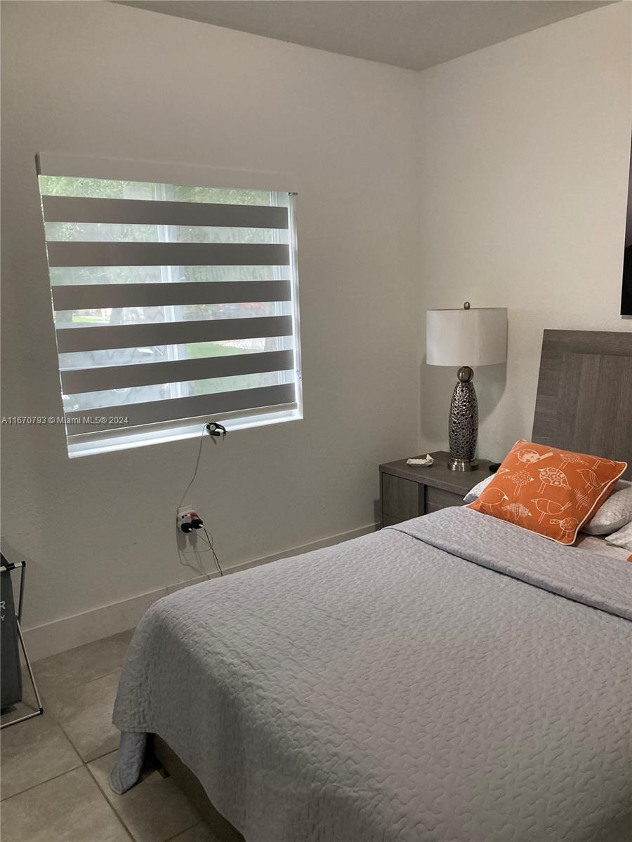 10831 West Old Cutler Road Miami, FL 33170 - Photo 8 of 14 a bedroom with a bed and window