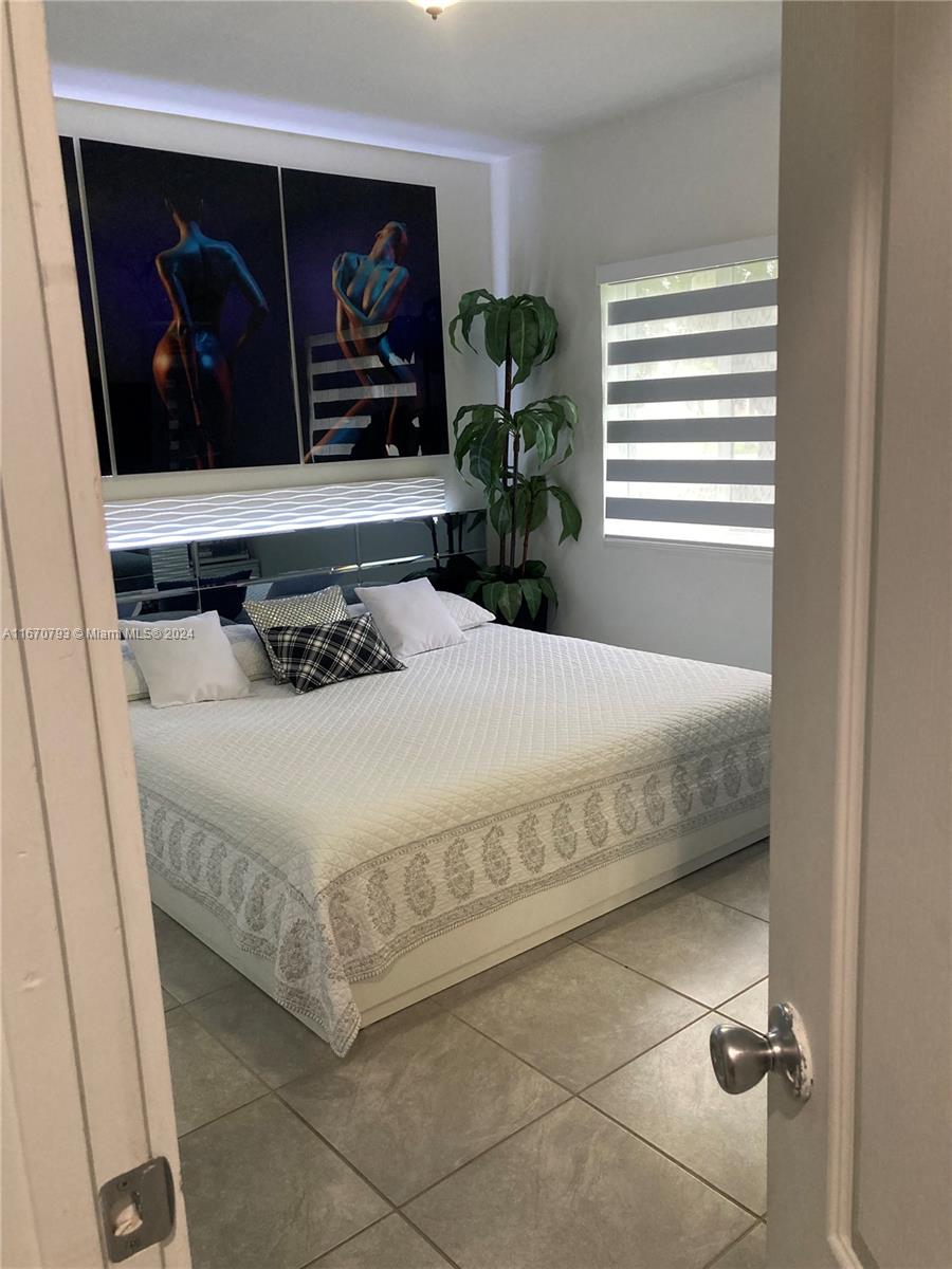 10831 West Old Cutler Road Miami, FL 33170 - Photo 9 of 14 a bedroom with a bed and a window