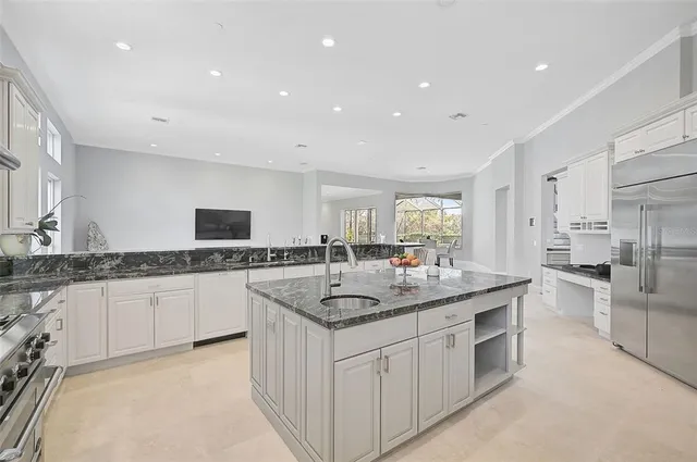 a bedroom with a bed a window and a flat screen tv