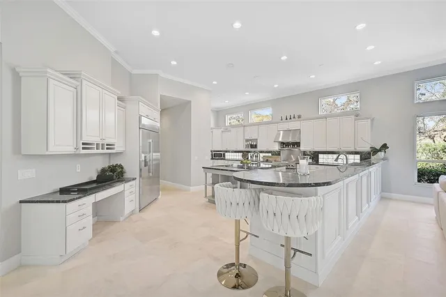 a kitchen with stainless steel appliances granite countertop a sink and a stove