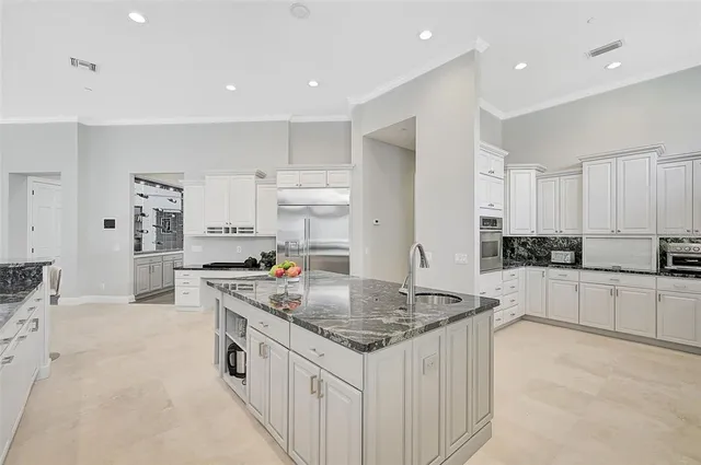 a spacious bedroom with a bed and a ceiling fan