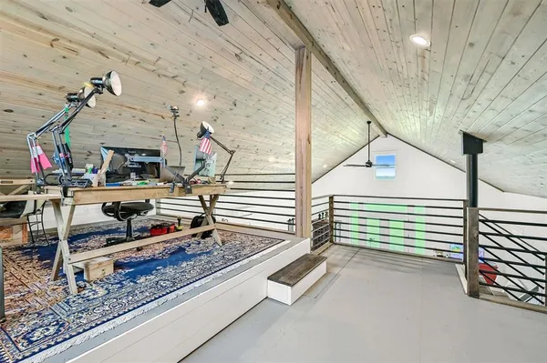 a view of a house next to a big yard and large trees