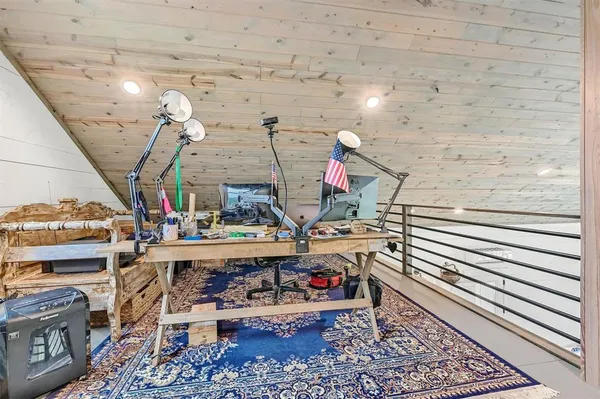 a view of a lush green field with lots of green plants and some trees