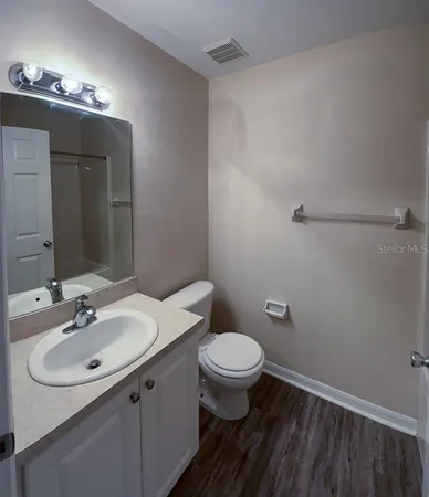 a bathroom with a sink toilet and mirror