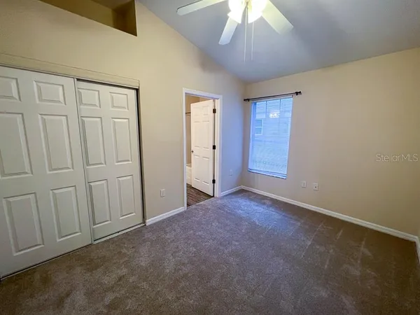 an empty room with a empty space and a ceiling fan