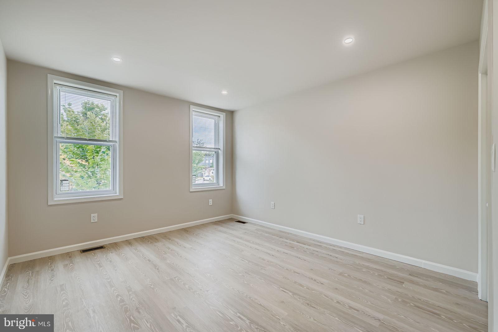 1729 North Fulton Avenue Baltimore, MD 21217 - Photo 13 of 30 an empty room with wooden floor and windows