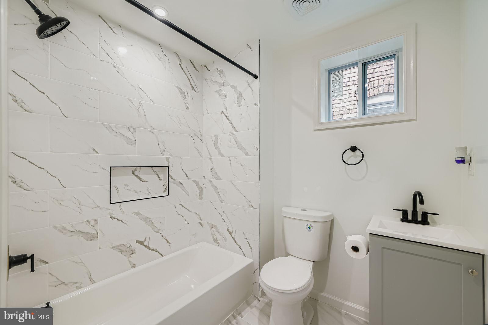 1729 North Fulton Avenue Baltimore, MD 21217 - Photo 16 of 30 a bathroom with a toilet and a tub