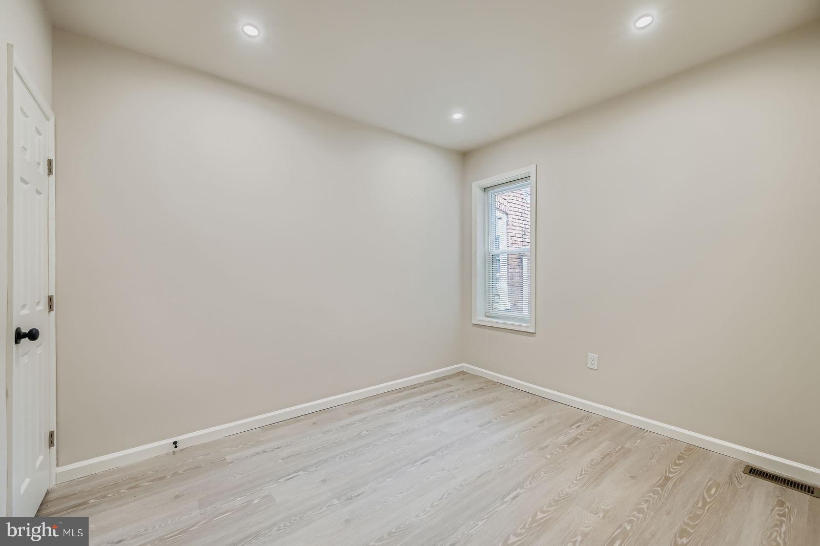 1729 North Fulton Avenue Baltimore, MD 21217 - Photo 19 of 30 an empty room with wooden floor and windows