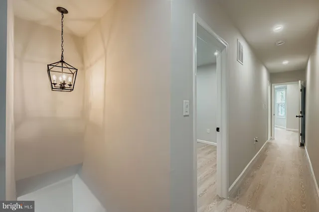 a view of a hallway with a refrigerator