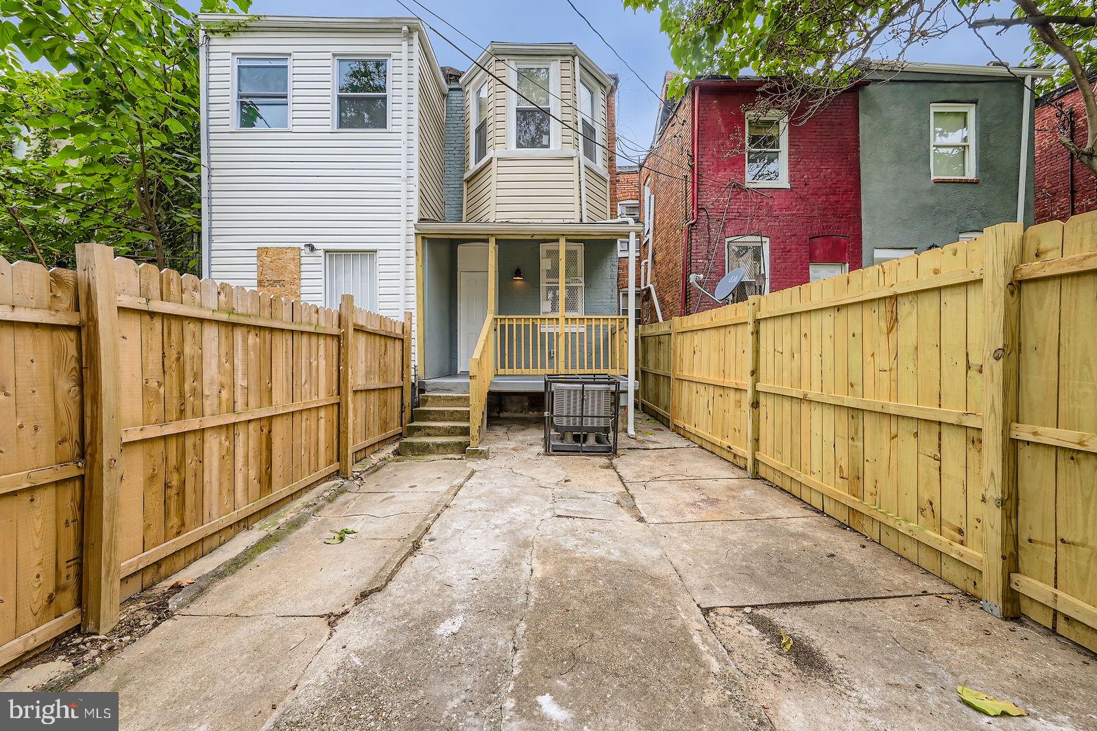1729 North Fulton Avenue Baltimore, MD 21217 - Photo 26 of 30 a view of a house with a wooden fence and a large window