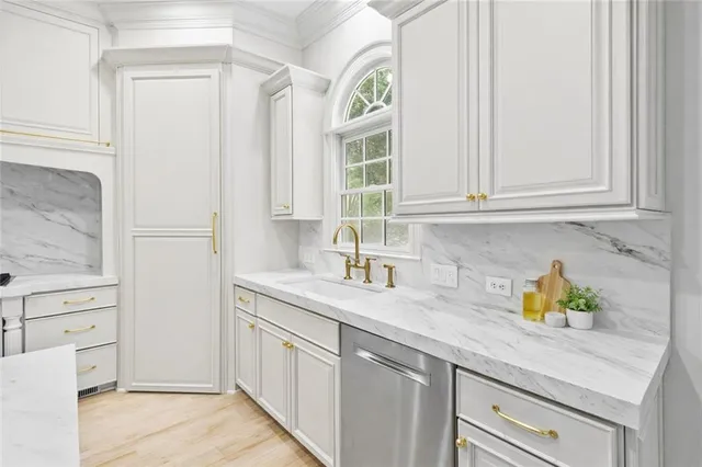 a kitchen with stainless steel appliances granite countertop a sink a stove and a window