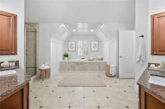 a spacious bathroom with a granite countertop sink and a mirror