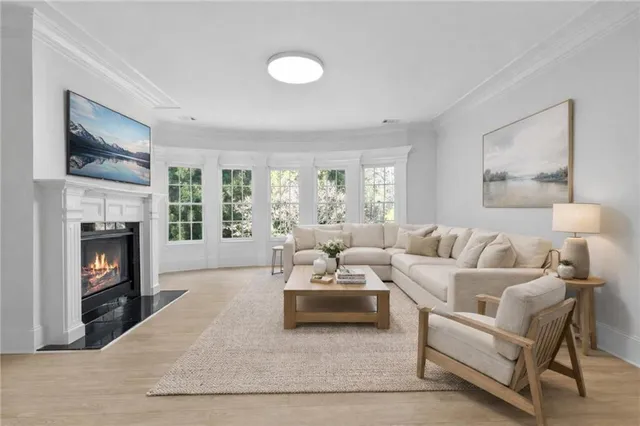 a view of an empty room with a fireplace and a window