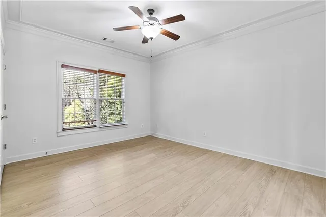 a view of a hallway with wooden floor and stairs