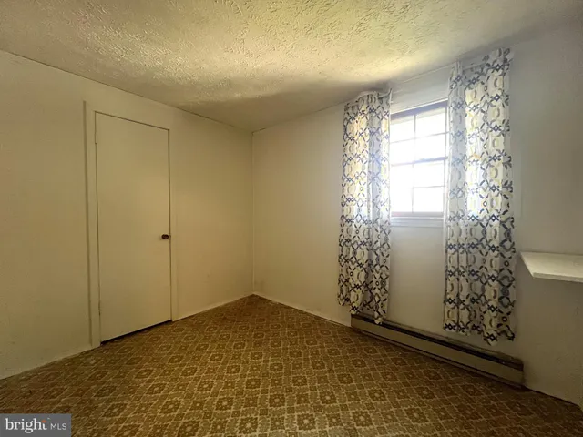 a view of room with window and carpet