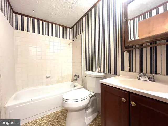 a bathroom with a sink a toilet and bathtub