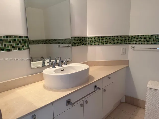 a view of a bathroom with a sink and mirror