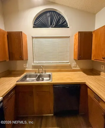 a view of an empty room with a fireplace and a window