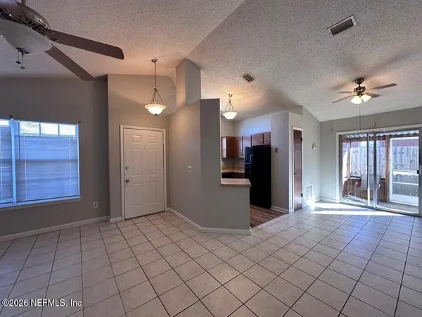 a view of an empty room and wooden floor