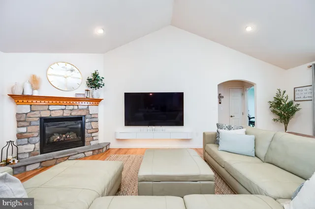 a large kitchen with a table chairs and a flat screen tv