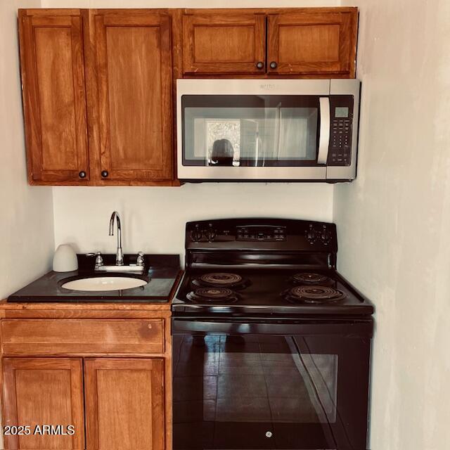 330 2nd Street Bowie, AZ 85605 - Photo 4 of 10 a kitchen with a stove and a microwave