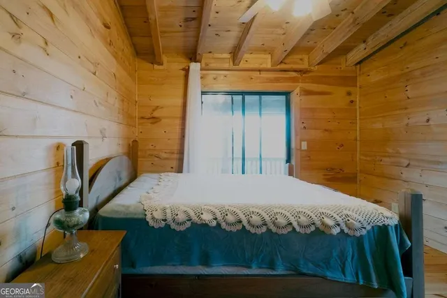 a bed sitting in a bedroom next to a bathroom