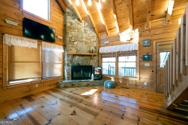 a view of empty room with wooden floor and fireplace