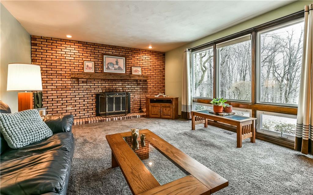 1254 Cornplanter Road Cabot, PA 16023 - Photo 3 of 23 The large Living Room with a log burning fireplace and huge picture window is the perfect room for gathering and spending time together.