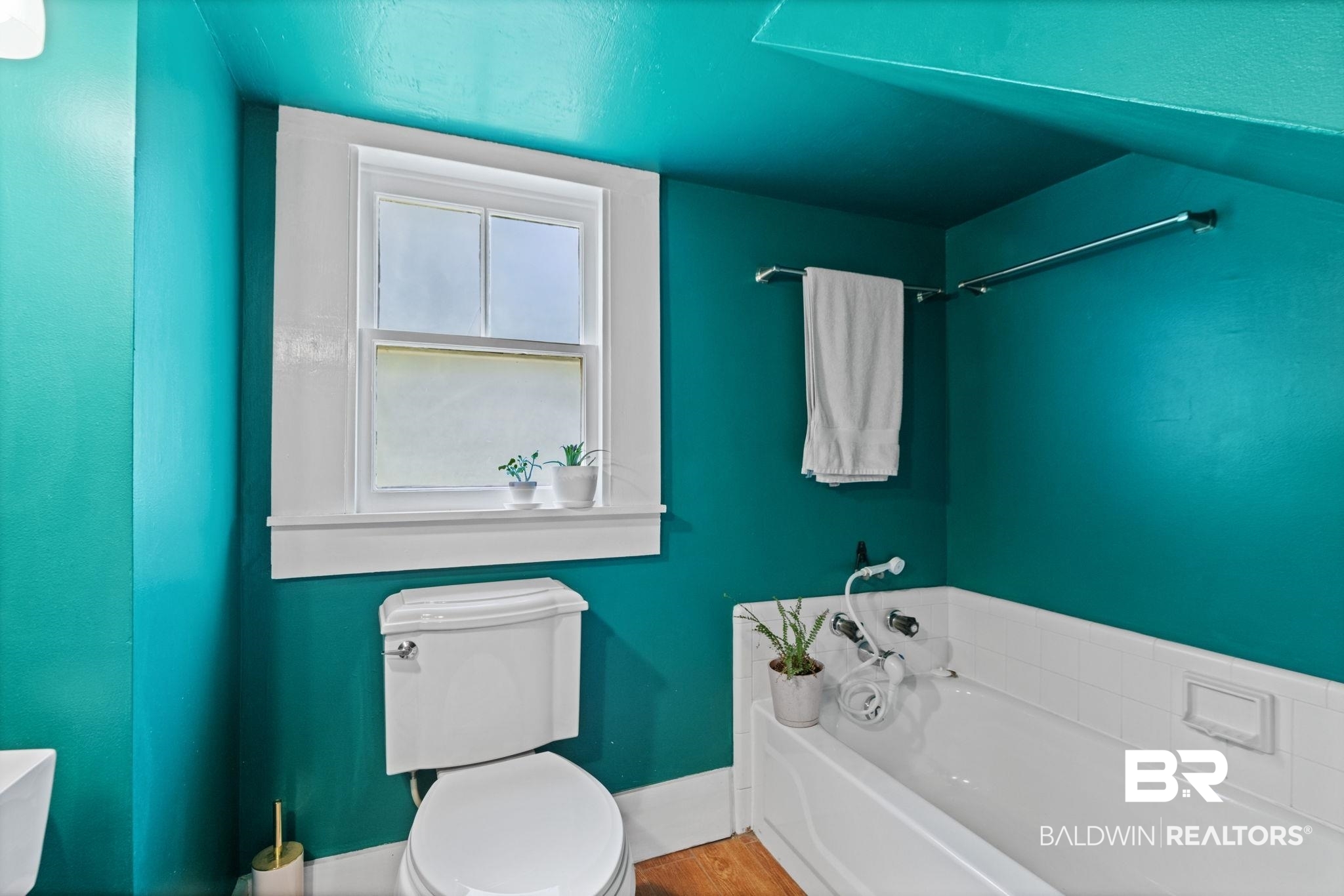 324 4th Street Mobile, AL 36611 - Photo 18 of 28 Bathroom with a bathtub, hardwood / wood-style floors, and toilet