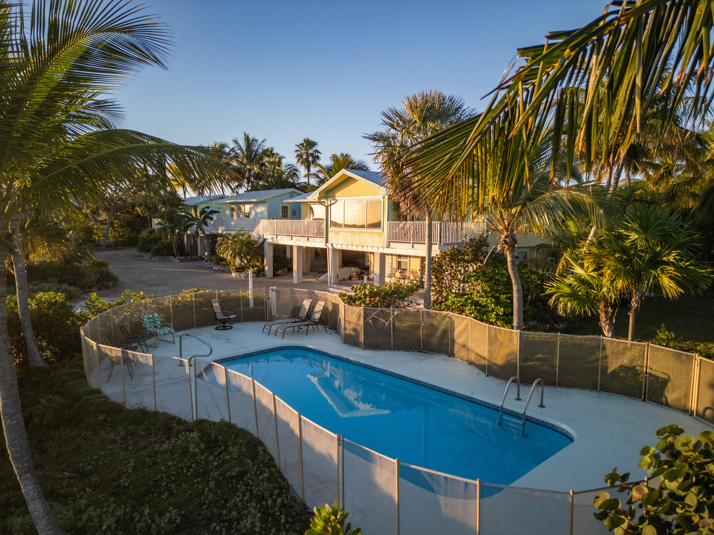 17385 Keystone Road Sugarloaf, FL 33042 - Photo 23 of 74 a view of a swimming pool with a patio and a garden