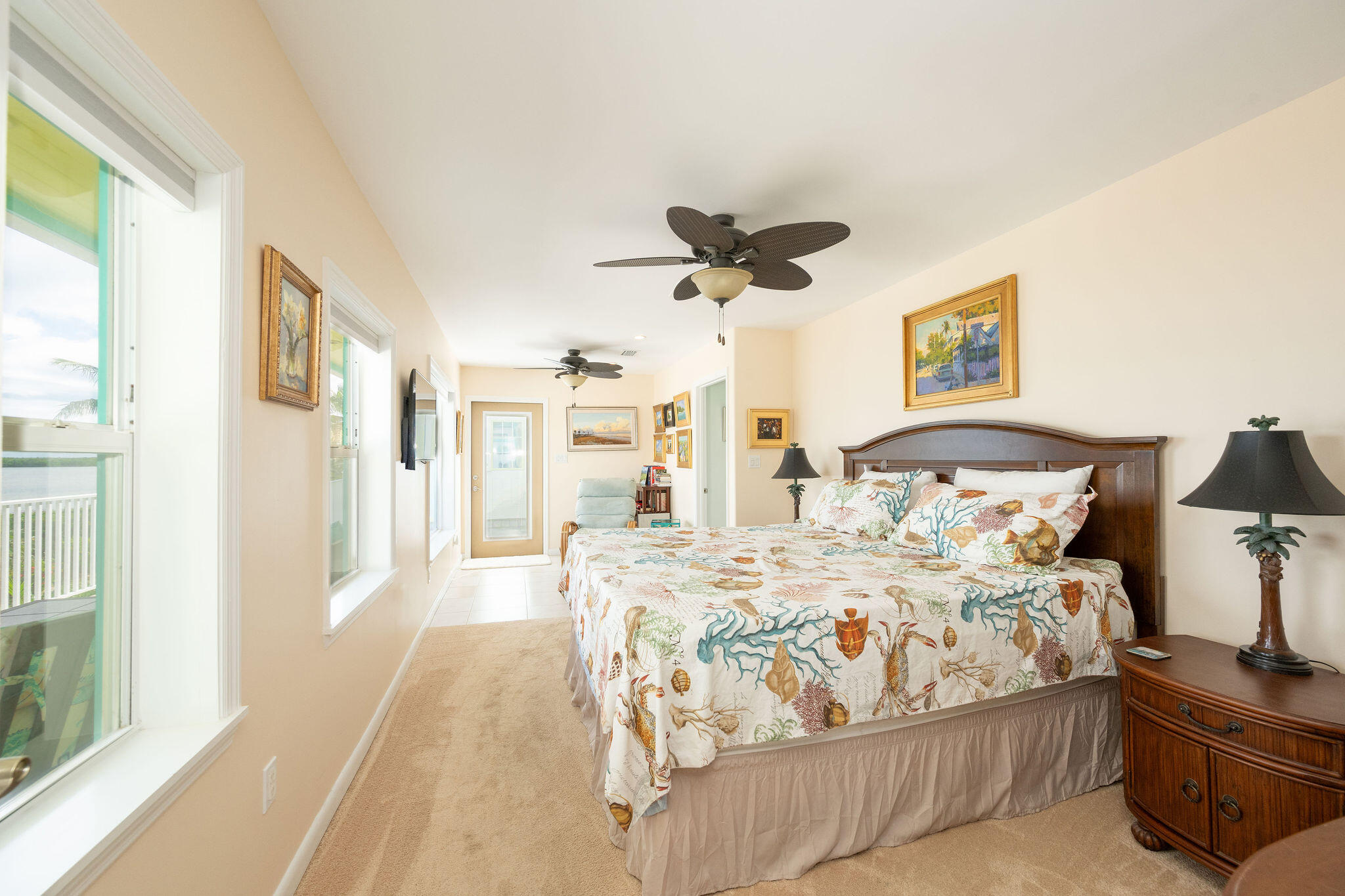 17385 Keystone Road Sugarloaf, FL 33042 - Photo 60 of 74 a bedroom with a bed and a chandelier