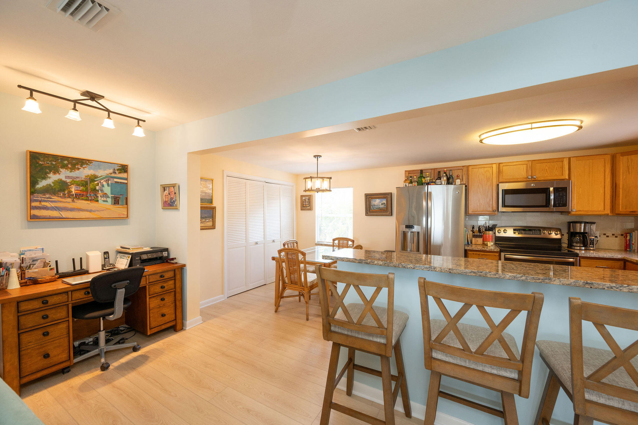 17385 Keystone Road Sugarloaf, FL 33042 - Photo 67 of 74 a kitchen with stainless steel appliances kitchen island granite countertop a dining table chairs and a refrigerator