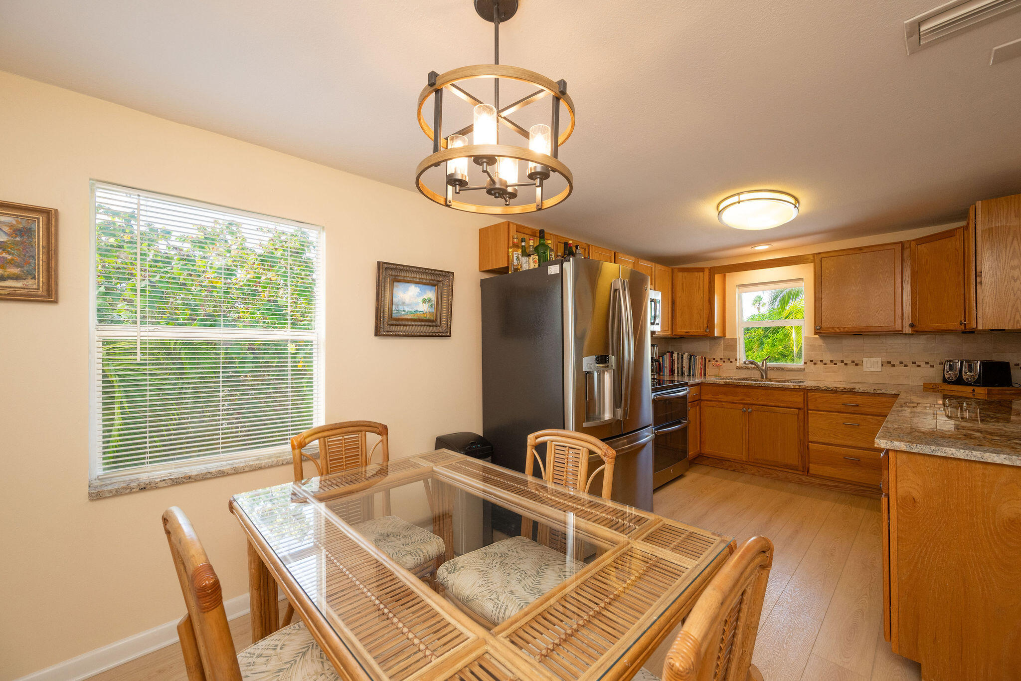 17385 Keystone Road Sugarloaf, FL 33042 - Photo 69 of 74 a kitchen with stainless steel appliances granite countertop a sink dishwasher a dining table and chairs with wooden floor