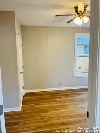 a view of room with window and wooden floor