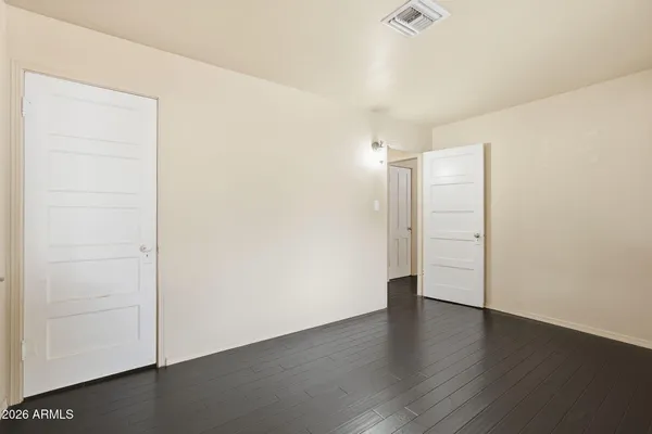 an empty room with wooden floor